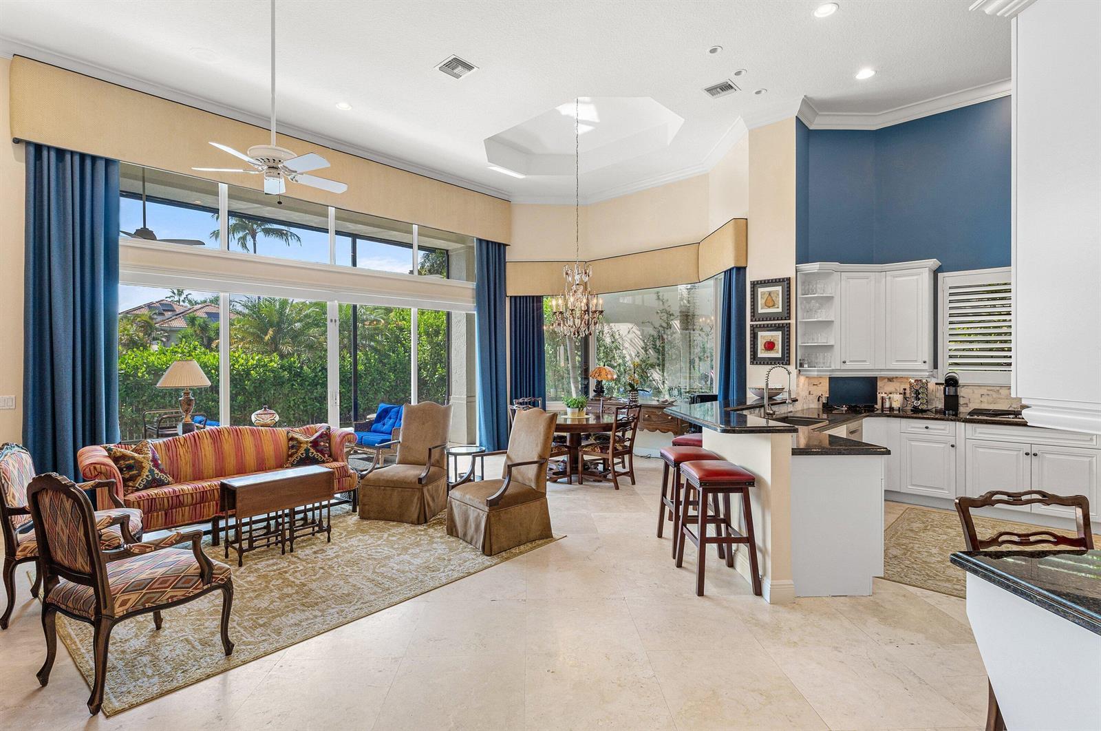 A view of a house exterior featuring a green lawn, palm trees, and landscaping — 7011 Islegrove Place, Boca Raton FL 33433, BOCA RATON, FL