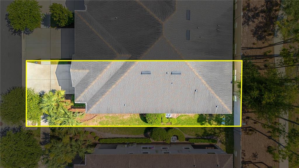An aerial view shows the roof of a residential house with a yellow outline — 10316 HOLSTEIN EDGE PLACE, RIVERVIEW, FL