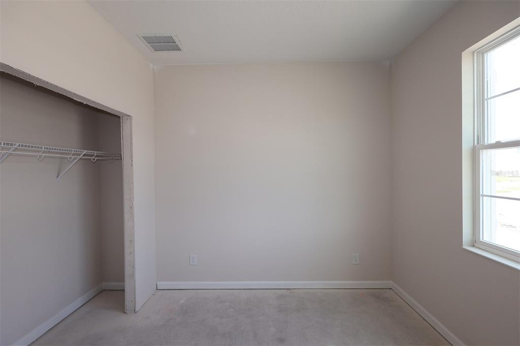 A kitchen features white cabinets, a central island with a sink, and wood-look tile flooring — 2679 GREAT HERON AVENUE, ST CLOUD, FL