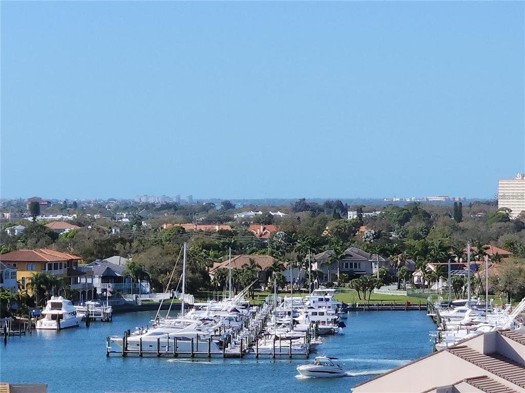 An elevated view of a marina filled with boats and surrounding residential homes — 5950 PELICAN BAY PLAZA S UNIT 505, GULFPORT, FL