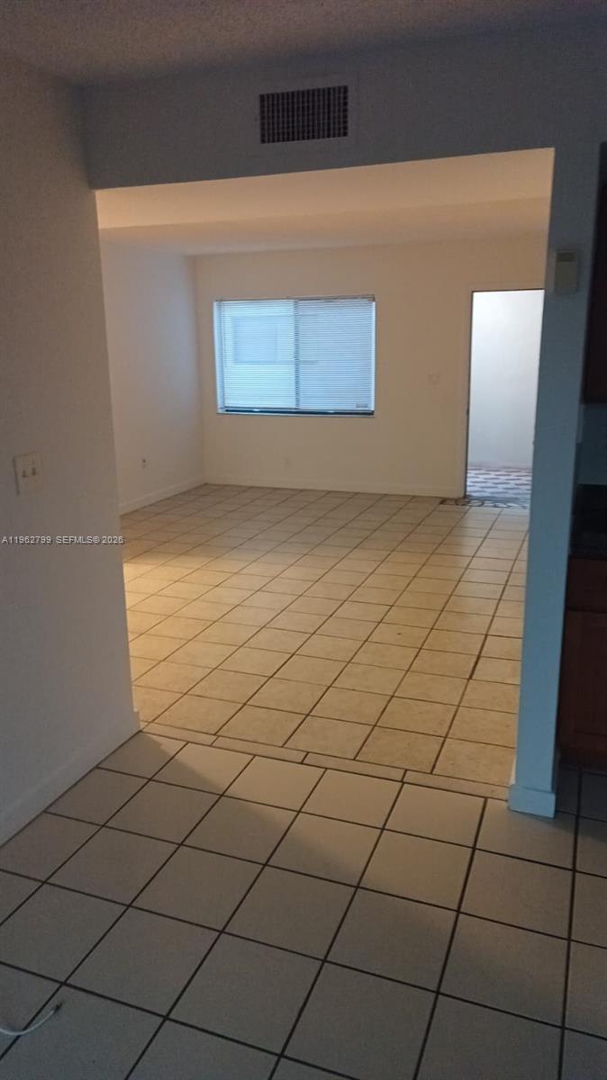 A tiled living area features a window with blinds and an adjacent doorway — 8400 SW 133rd Ave Rd # 318, Miami FL 33183, MIAMI, FL