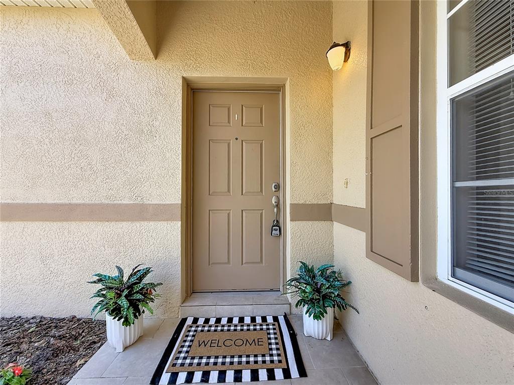 A kitchen features wood cabinets, stainless steel appliances, and granite countertops — 1027 ORCA COURT, HOLIDAY, FL