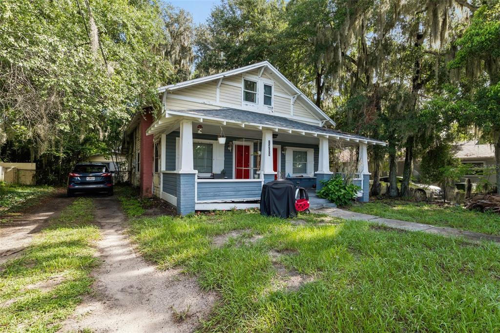 A detached concrete block building with a red door sits on a concrete slab — 1408 HIGH STREET UNIT C, LEESBURG, FL
