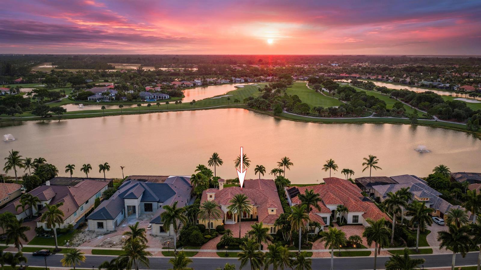 An aerial view of a waterfront house with a tile roof at sunset — 7287 Horizon Drive, West Palm Beach FL 33412, WEST PALM BEACH, FL
