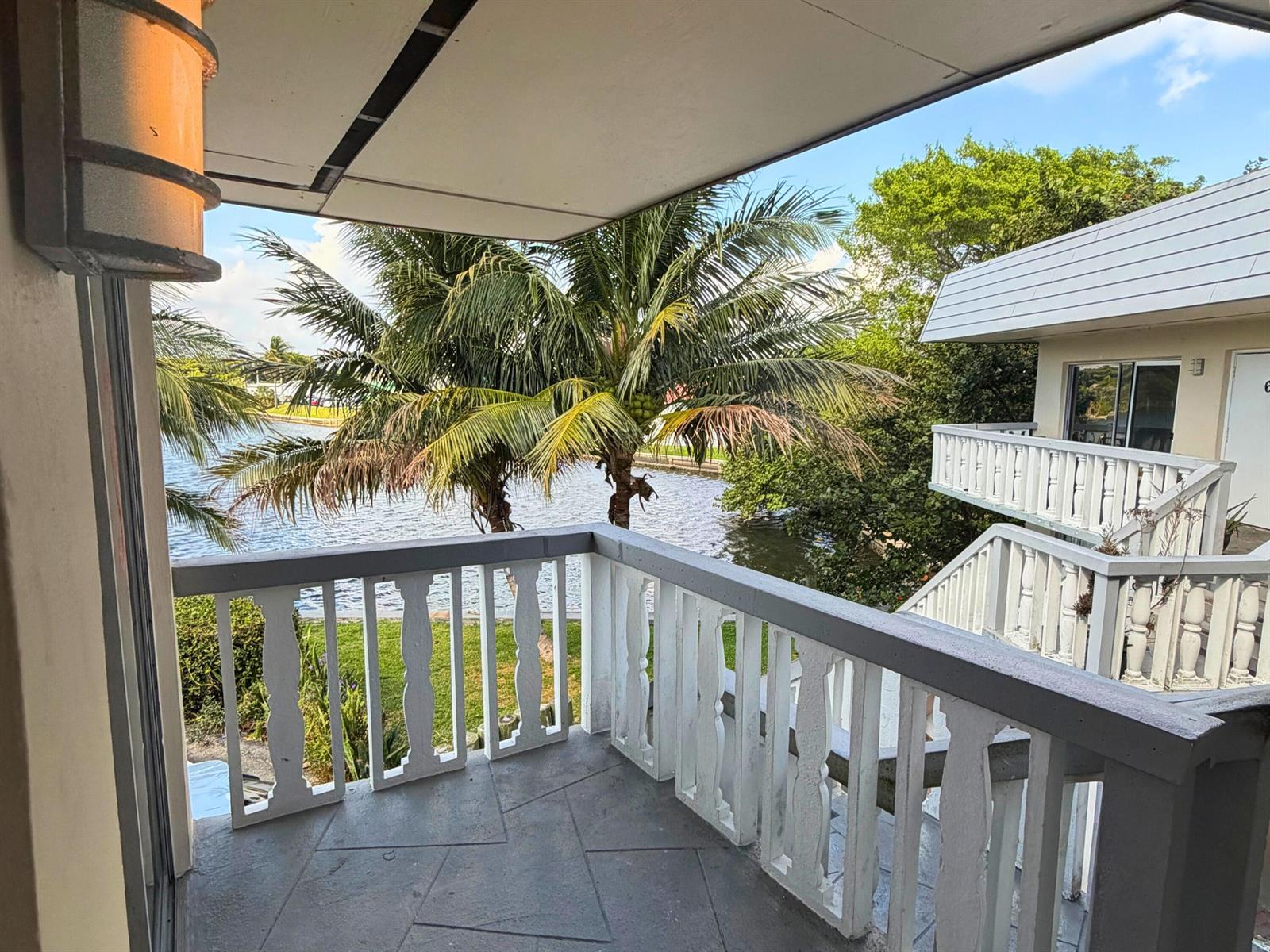 A two-story apartment building with a white exterior, blue trim, and a parking lot — 519 W Kalmia Drive # 2, West Palm Beach FL 33403, WEST PALM BEACH, FL