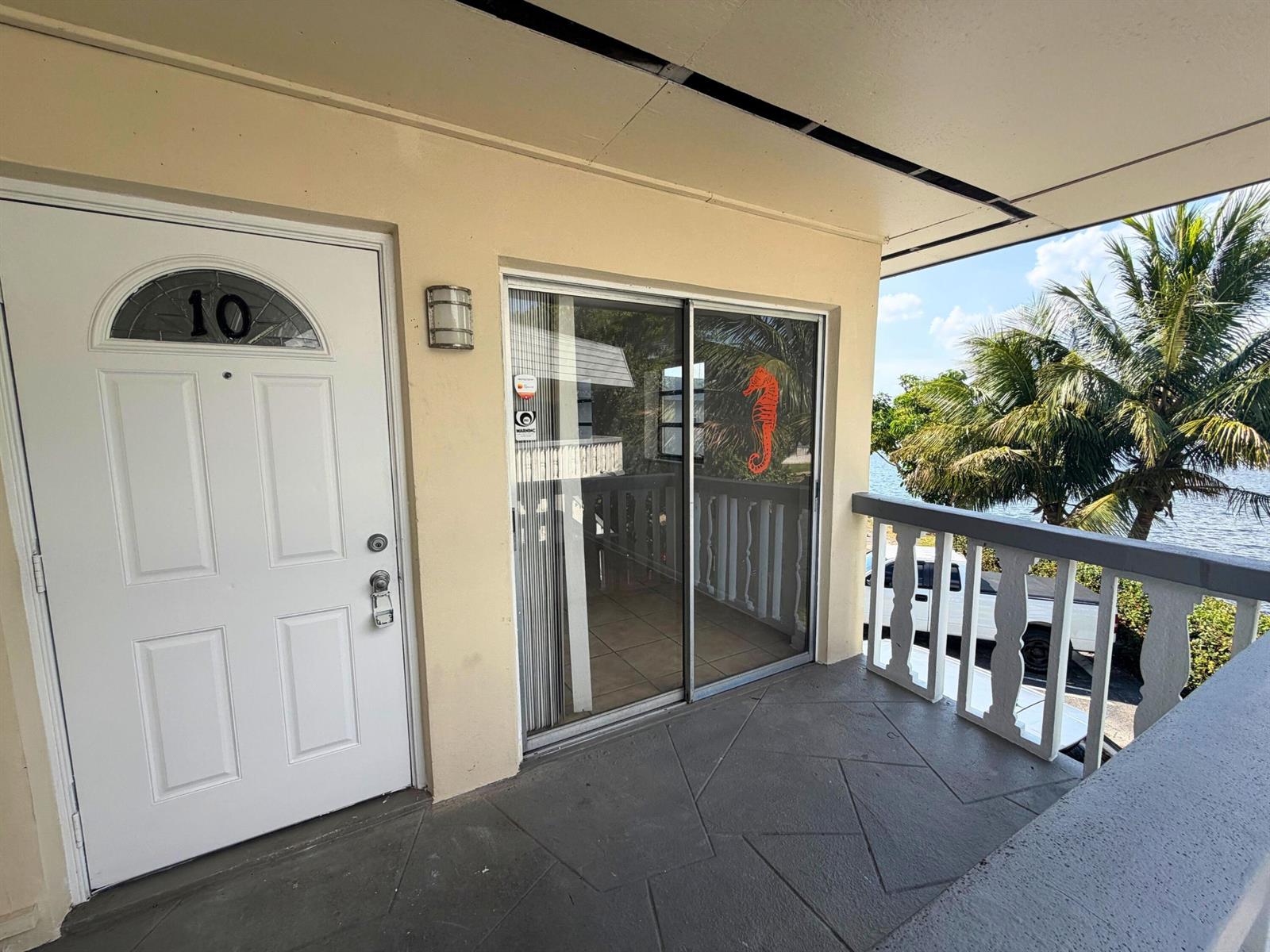 A two-story apartment building with a parking lot and a white SUV in front — 519 W Kalmia Drive # 2, West Palm Beach FL 33403, WEST PALM BEACH, FL