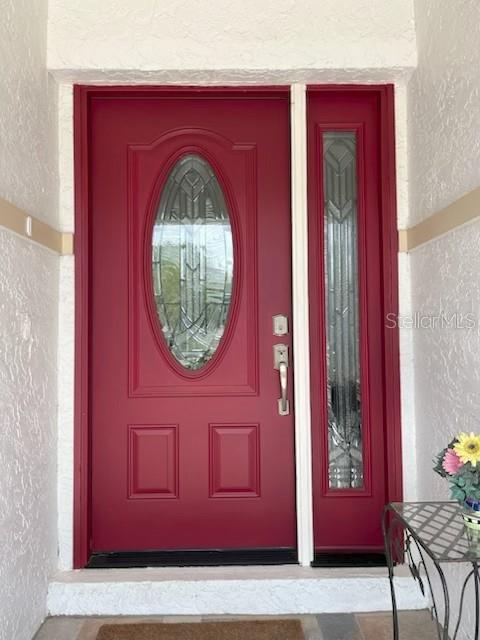 A red front door with an oval glass insert and a matching side light — 4716 61ST AVENUE TERRACE W UNIT 4716, BRADENTON, FL