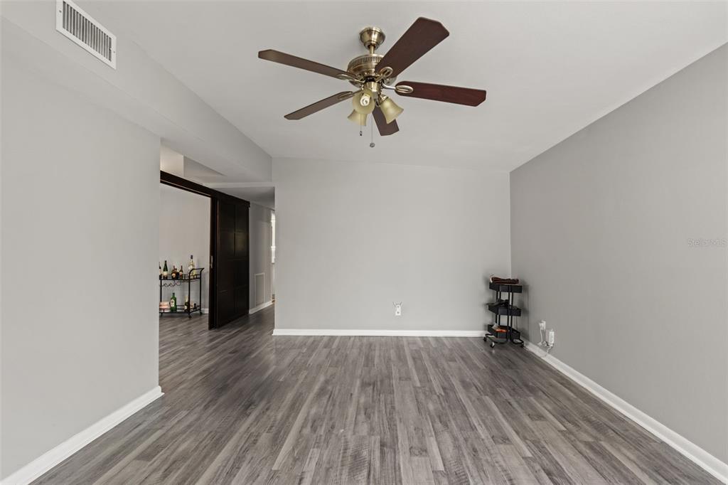 A room with gray walls, wood-look flooring, and a ceiling fan — 2116 W ABDELLA STREET, TAMPA, FL