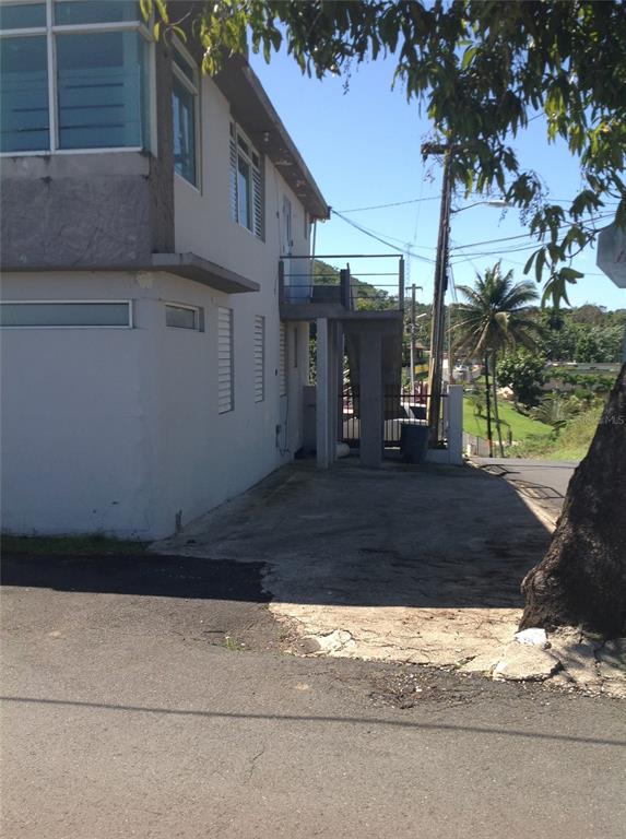 A two-story building with an exterior staircase and a concrete driveway under a clear sky — PR-837 KM 3.2 SANTA ROSA WARD, SECTOR EL LLANO UNIT A69 & A68, GUAYNABO, PR