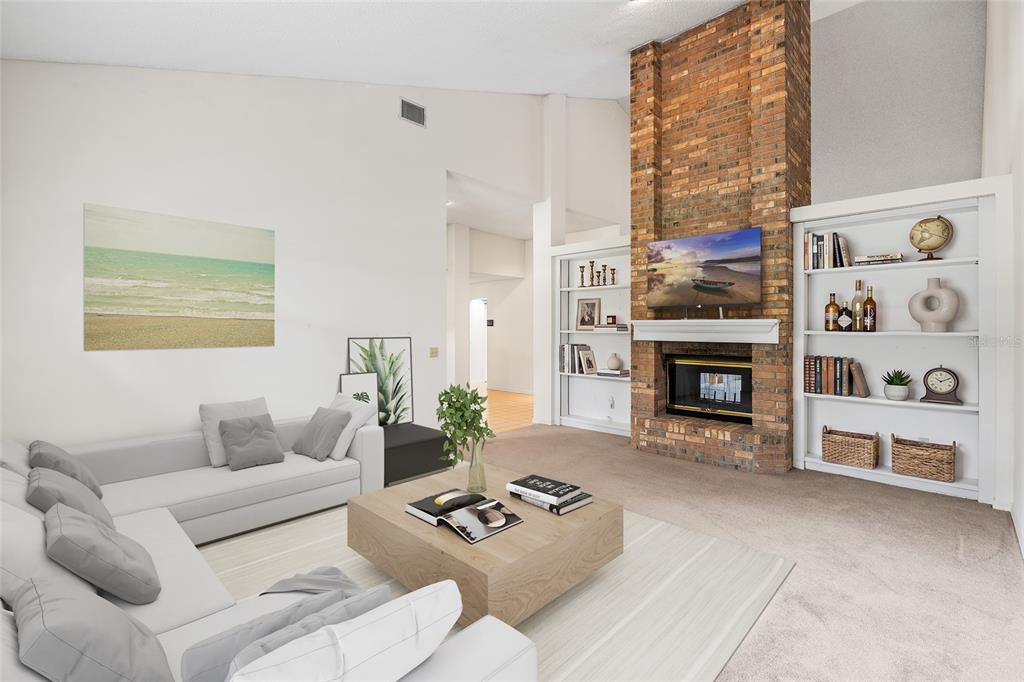 A living room features a brick fireplace, built-in white shelving, and a light-colored sectional sofa — 2555 MASON OAKS DRIVE, VALRICO, FL
