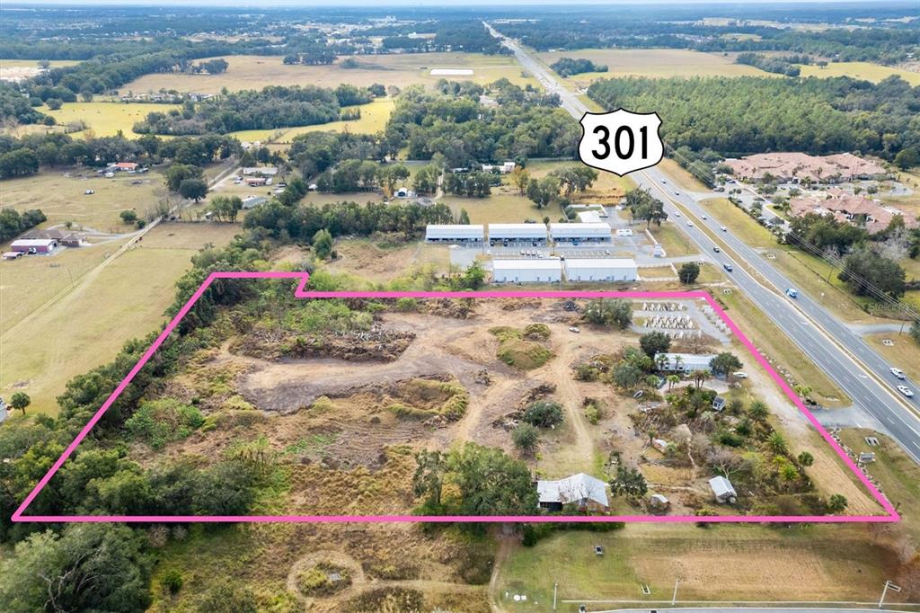 An aerial view shows a large, cleared rectangular plot of land adjacent to Highway 301 — 10973 N US HIGHWAY 301, OXFORD, FL