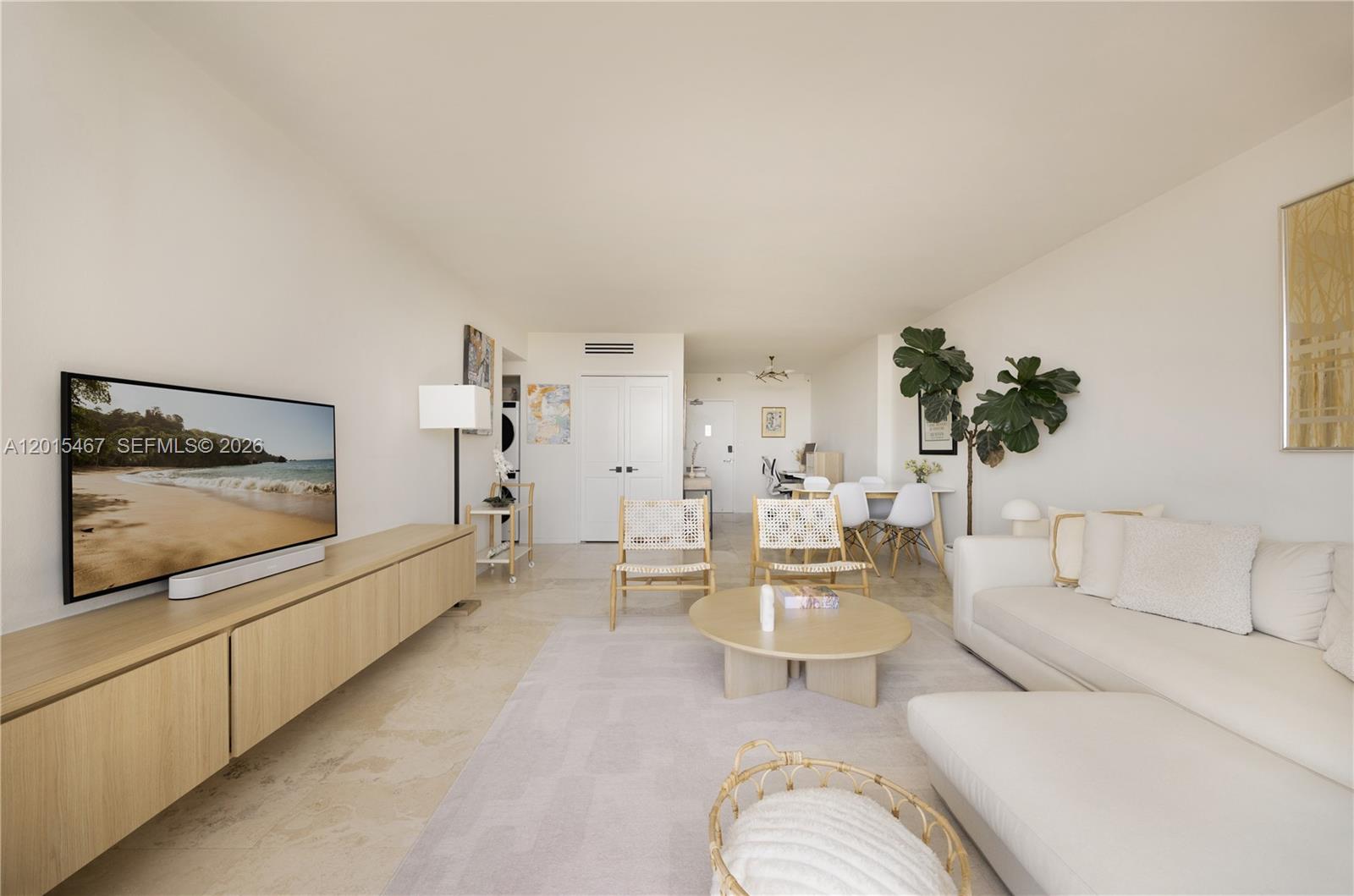 A bright living room features a white sofa, round coffee table, and light wood media console — 1200 West Ave # 1410, Miami Beach FL 33139, MIAMI BEACH, FL