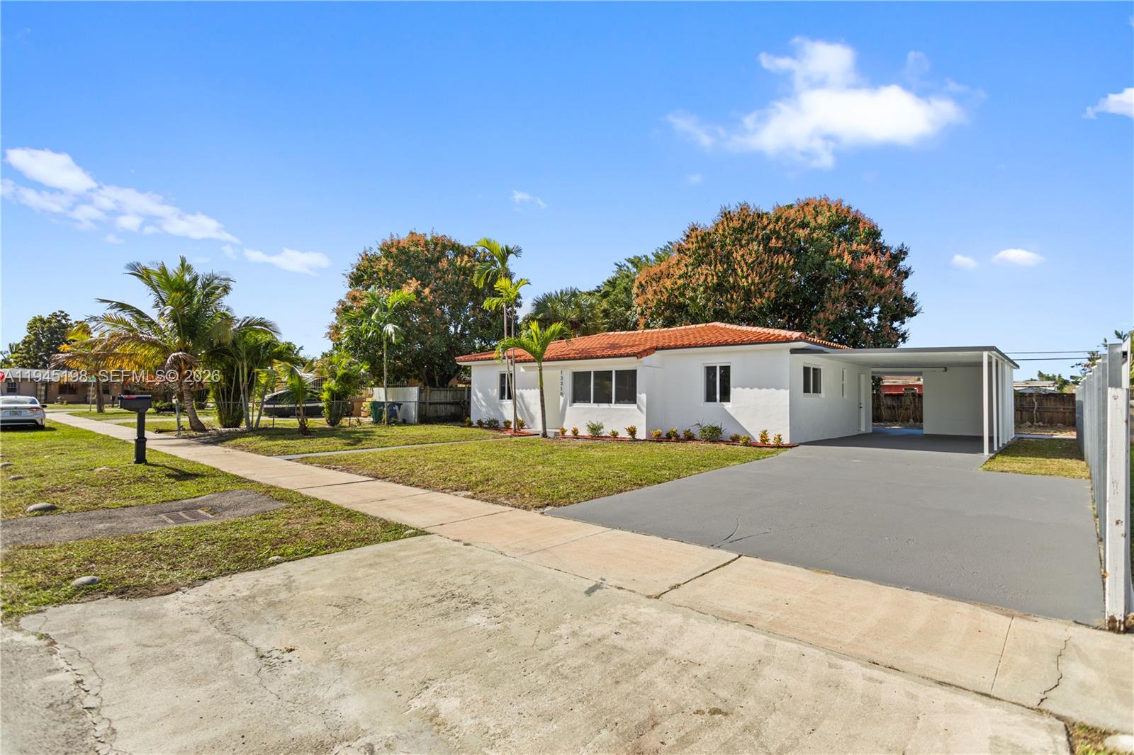 A white single-story house with a red tile roof and an attached carport — 13310 NW 17th Pl, Miami FL 33167, MIAMI, FL