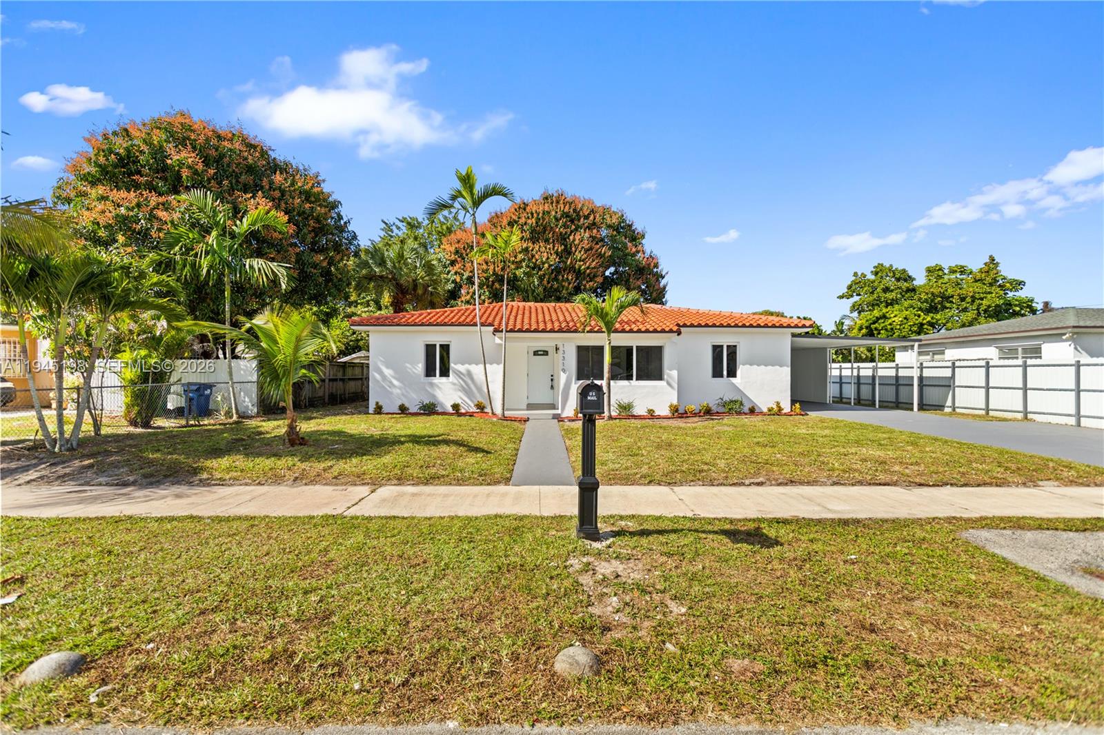 A single-story white house with a red tile roof and a front lawn — 13310 NW 17th Pl, Miami FL 33167, MIAMI, FL