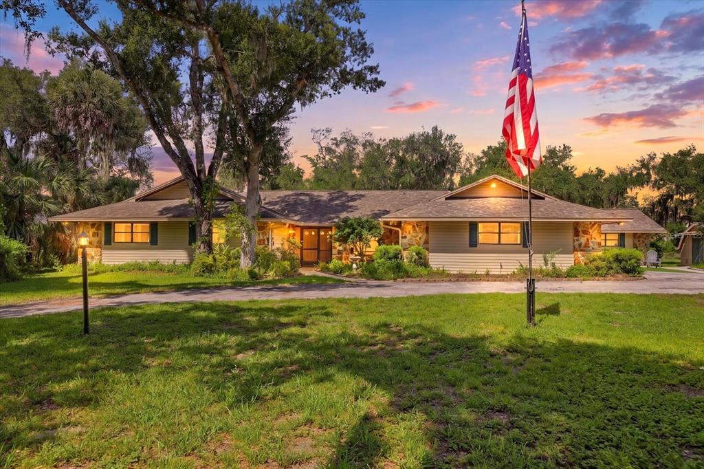 An aerial view shows a house on a large, grassy lot with a pond — 5850 VANDERIPE ROAD, SARASOTA, FL