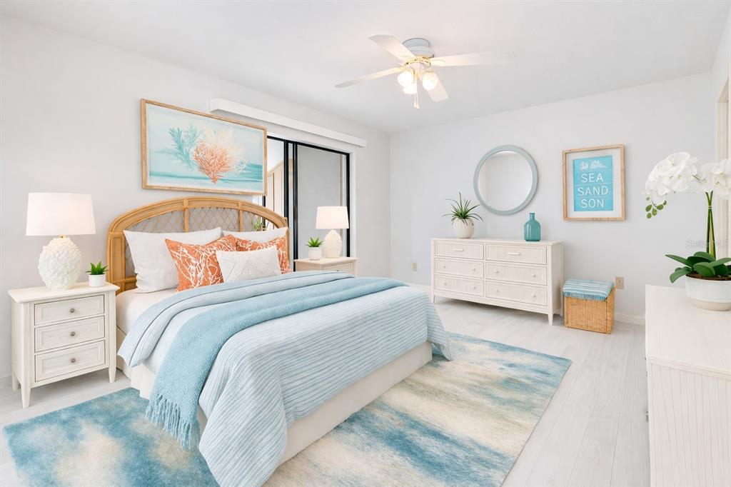 A bright bedroom features a rattan headboard, blue bedding, white furniture, and a coastal rug — 4152 66TH STREET CIRCLE W, BRADENTON, FL