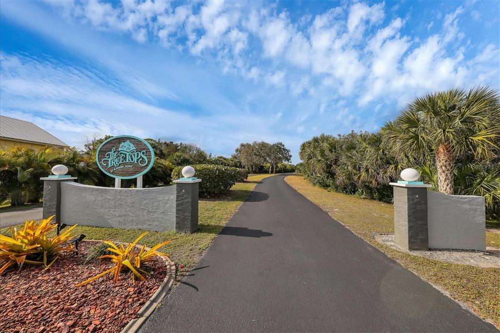 A paved driveway leads past a sign for The Treetops at Ranger Point — 4280 OAK TERRACE CIRCLE, PORT CHARLOTTE, FL