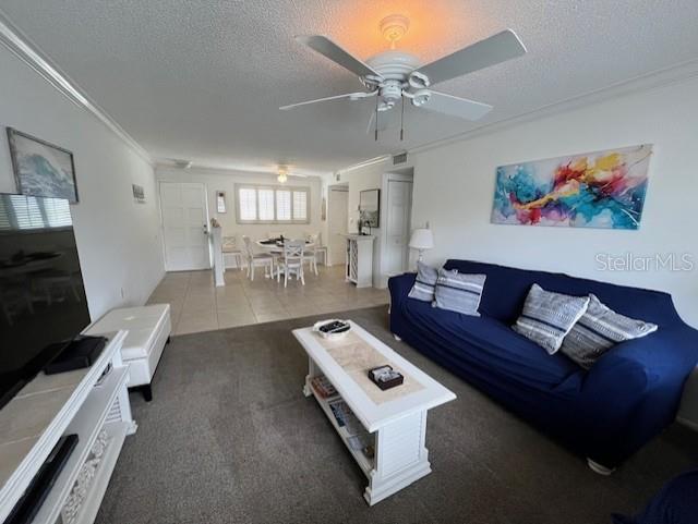 A living room features a blue sofa, a white coffee table, and a ceiling fan — 6703 MIDNIGHT PASS ROAD UNIT 217, SARASOTA, FL