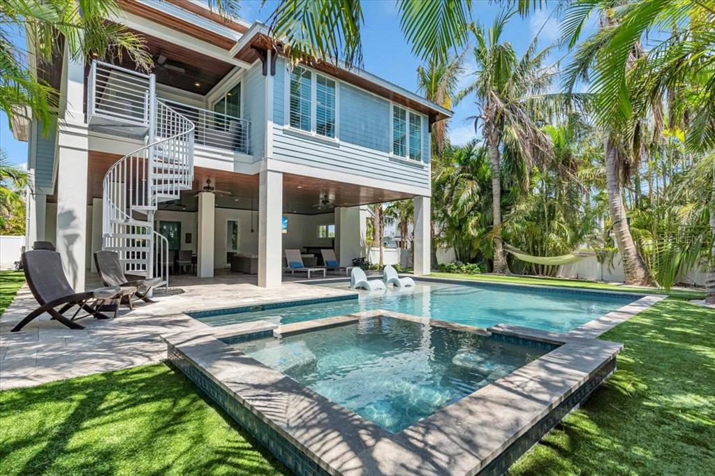A two-story house with a spiral staircase, swimming pool, hot tub, and patio area — 222 WILLOW AVENUE, ANNA MARIA, FL