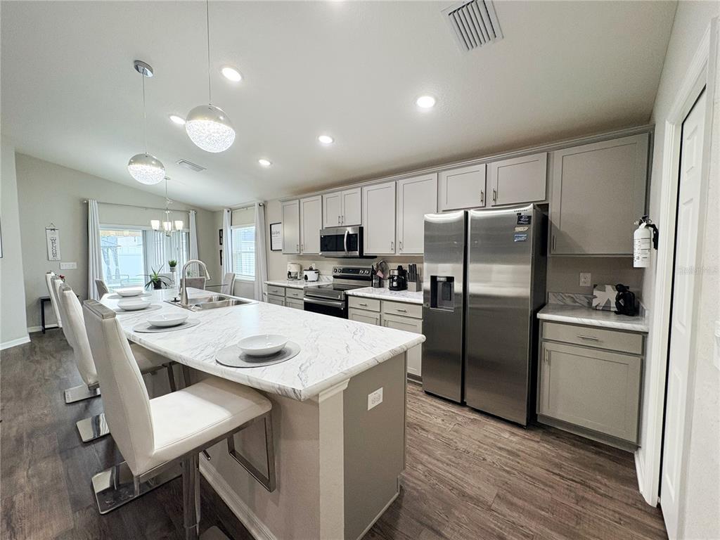 A gated entrance with signage and a security arm at a residential community — 9134 SE 43RD TERR, OCALA, FL