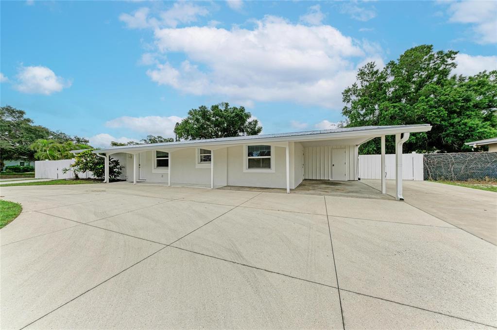 A single-story house with a large concrete driveway and an attached carport — 2714 DATURA STREET, SARASOTA, FL