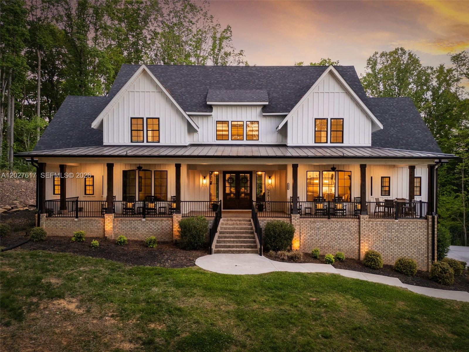 A two-story farmhouse with white vertical siding, a metal porch roof, and brick foundation — 1642 Pineview Road, NC 27317, NC