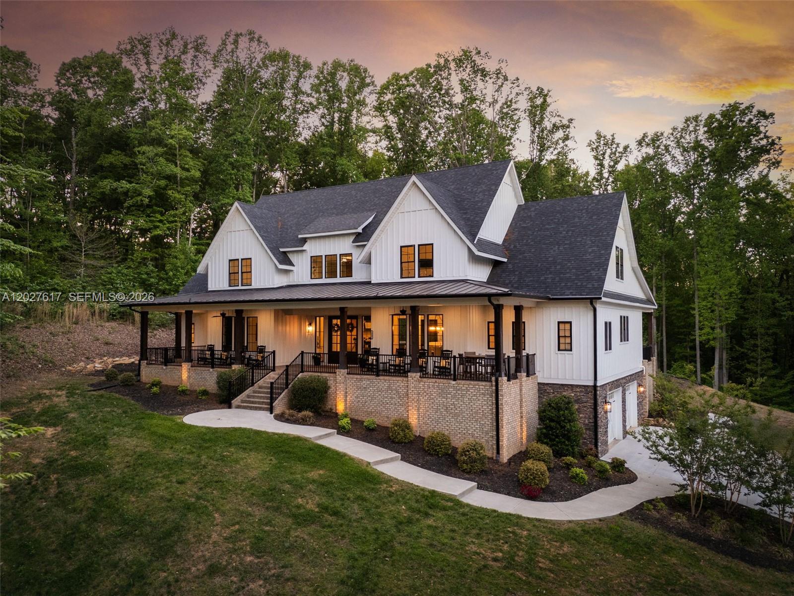 A two-story white farmhouse with a wrap-around porch, brick foundation, and attached garage — 1642 Pineview Road, NC 27317, NC