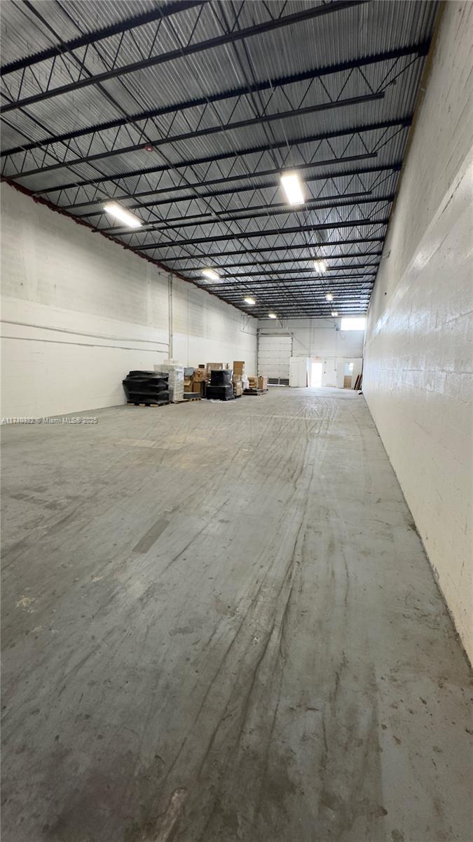 An empty warehouse interior features a concrete floor, white walls, and an exposed metal ceiling — 4201 NW 37th Ave # A, Miami FL 33142, MIAMI, FL