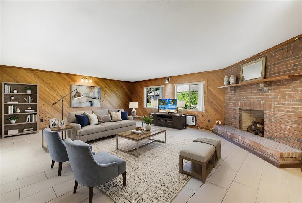 A living room features diagonal wood-paneled walls, a brick fireplace, and light-colored tile flooring — 10330 GALLIARD BOULEVARD, ORLANDO, FL