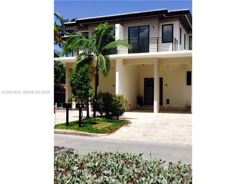 A two-story modern house features a balcony, a covered entryway, and a paved driveway — 474 Fernwood Rd # 474, Key Biscayne FL 33149, KEY BISCAYNE, FL