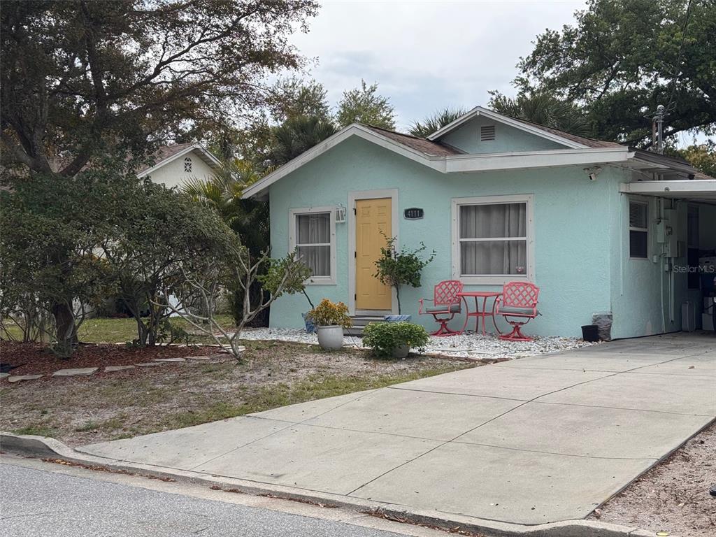 A light blue house with a yellow front door and a concrete driveway — 4111 SARASOTA AVENUE, SARASOTA, FL