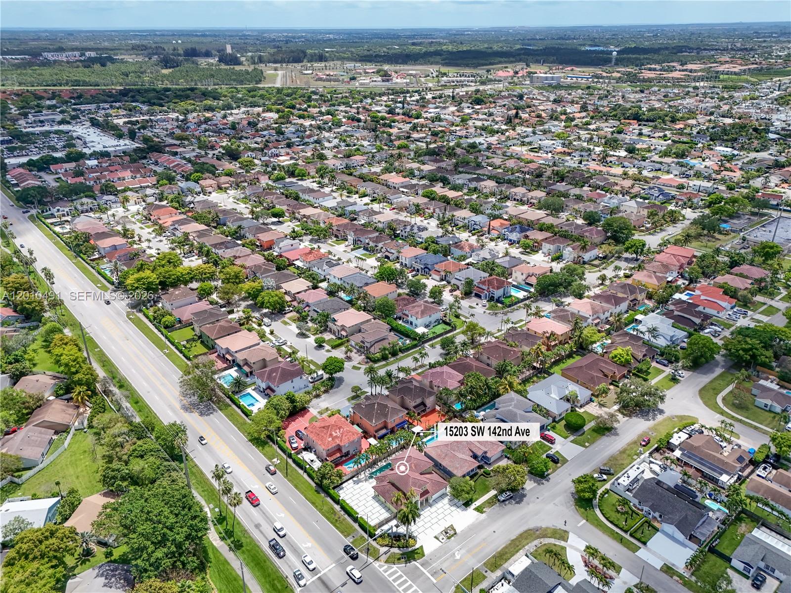 An aerial view shows a residential neighborhood with a highlighted house featuring a pool — 15203 SW 142nd Ave, Miami FL 33177, MIAMI, FL