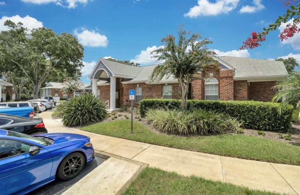 A single-story brick building with a covered entrance and a handicap parking sign outside — 5457 LAKE MARGARET DRIVE UNIT 19-1, ORLANDO, FL