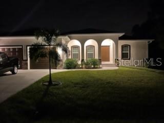 A single-story house with a three-arch entryway and a palm tree in the front yard — 13376 YAGER LANE, PORT CHARLOTTE, FL