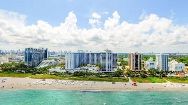An aerial view of a beachfront resort complex with multiple high-rise buildings along the coast — 102 24th St # 1021, Miami Beach FL 33139, MIAMI BEACH, FL