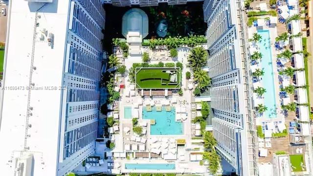 An aerial view of a high-rise apartment complex featuring multiple swimming pools and a courtyard — 102 24th St # 1021, Miami Beach FL 33139, MIAMI BEACH, FL