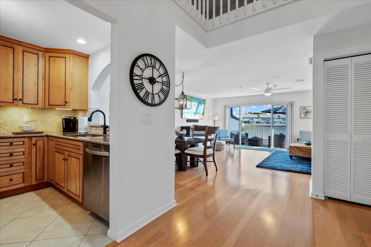 A view from a kitchen with wood cabinets into a dining area and living room — 1121 Ocean Dunes Circle, Jupiter FL 33477, JUPITER, FL