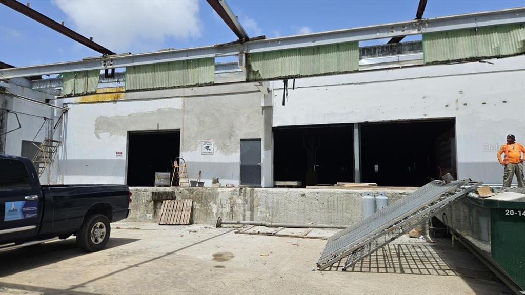 An exterior view of a commercial building undergoing renovation with an open loading dock area — PR 185 Km. 66 INT PR 3, CANOVANAS, PR