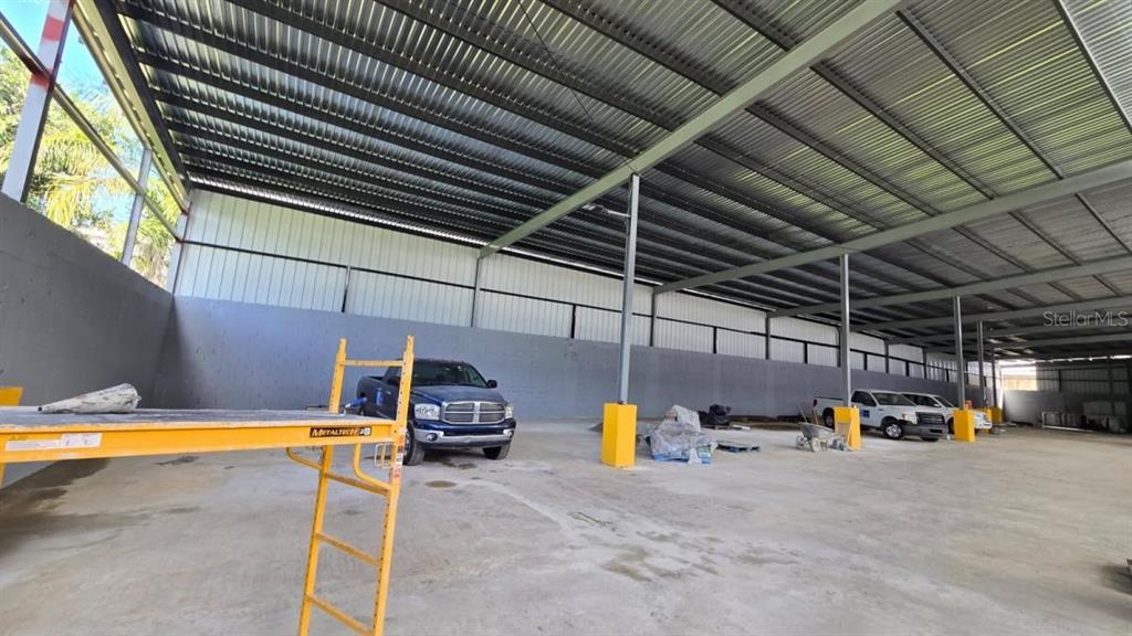 A large, open-air warehouse space features a metal roof, concrete flooring, and yellow support columns — PR 185 Km. 66 INT PR 3, CANOVANAS, PR
