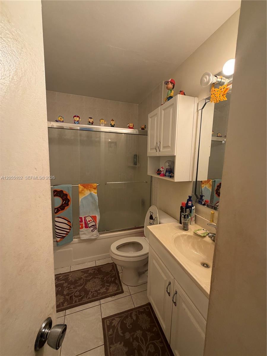 A bathroom features a shower-tub combination, a white vanity, and a toilet — 1727 NW 80th Ave # H, Margate FL 33063, MARGATE, FL