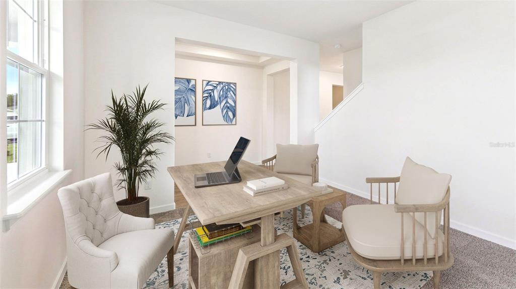 A home office features a wooden desk, two chairs, a potted plant, and wall art — 3020 KINGSMAN TRAIL, ORMOND BEACH, FL
