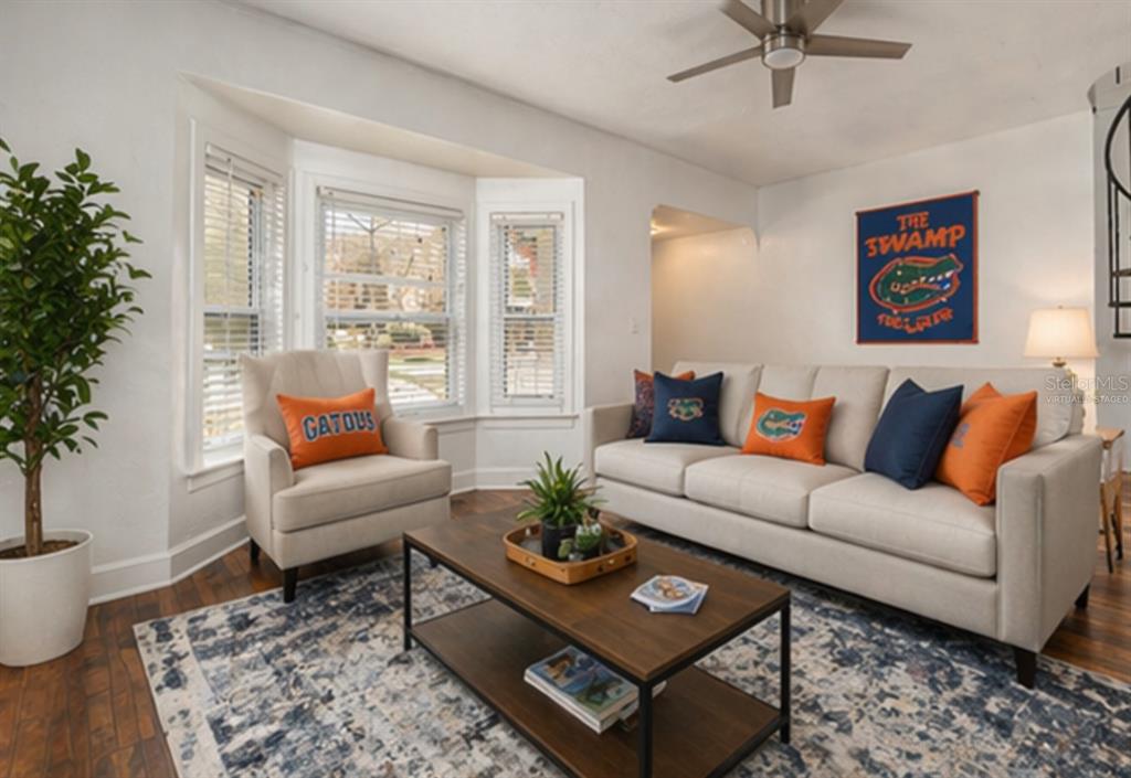 A living room features a sofa, armchair, coffee table, and Florida Gators decor — 1254 SW 9TH ROAD, GAINESVILLE, FL