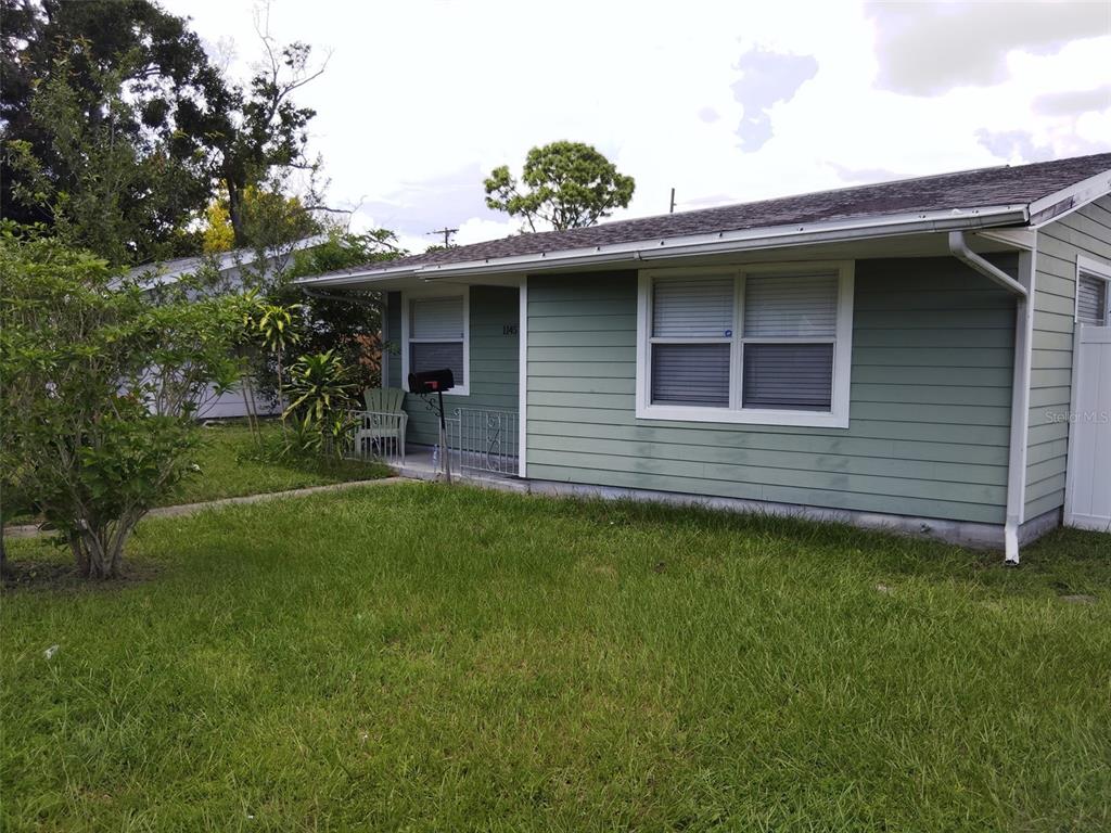 A light green single-story house with a front lawn and a small porch — 1145 54TH AVENUE N, ST PETERSBURG, FL
