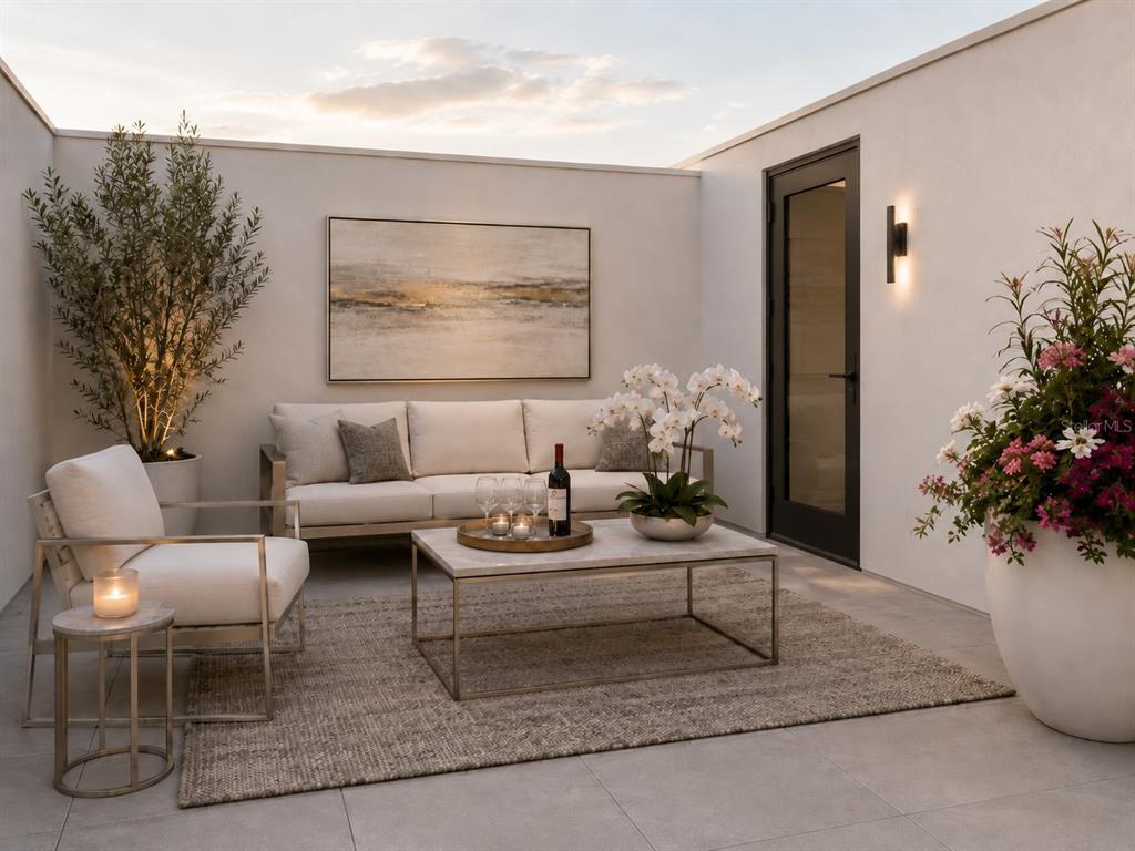 A modern outdoor patio features a sofa, armchair, coffee table, and potted plants against walls — 1305 4TH STREET UNIT 401G RT, SARASOTA, FL