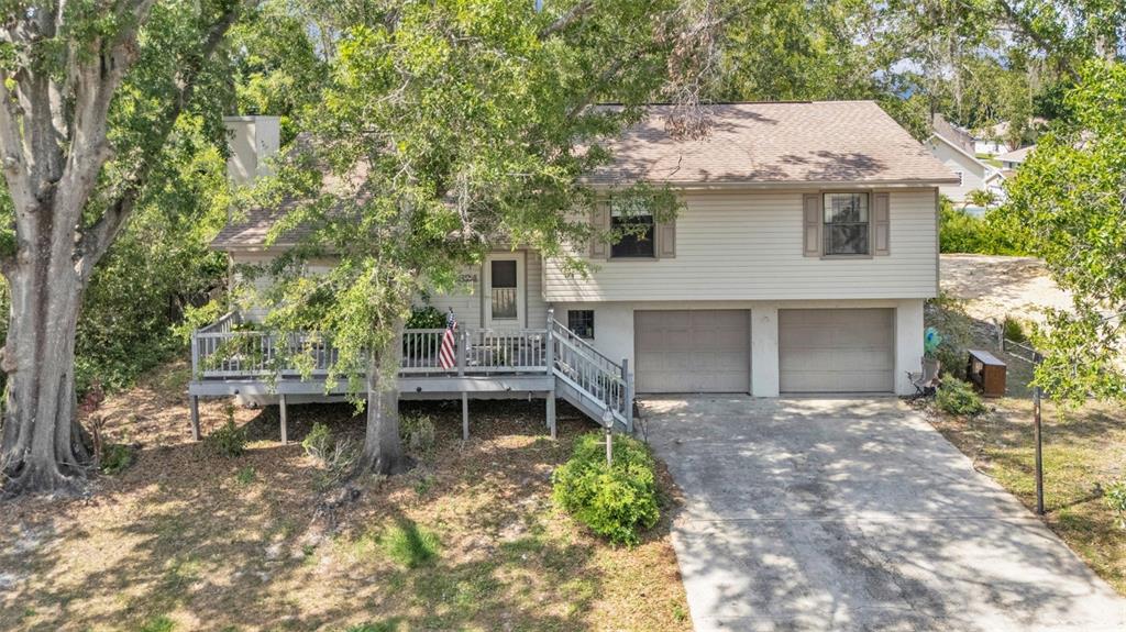 A two-story house with light siding, a front deck, and a two-car garage — 5324 LAFAYETTE AVENUE, SEBRING, FL