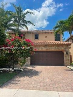 A two-story house with a tan stucco exterior, a tiled roof, and a paved driveway — 3837 Aspen Leaf Dr, Boynton Beach FL 33436, BOYNTON BEACH, FL