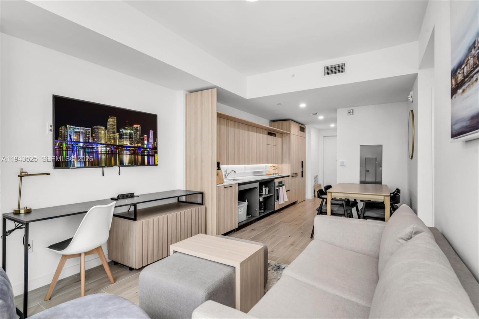 A modern studio apartment features a kitchenette, a dining area, and a living space — 225 N Miami Ave # 1005, Miami FL 33128, MIAMI, FL