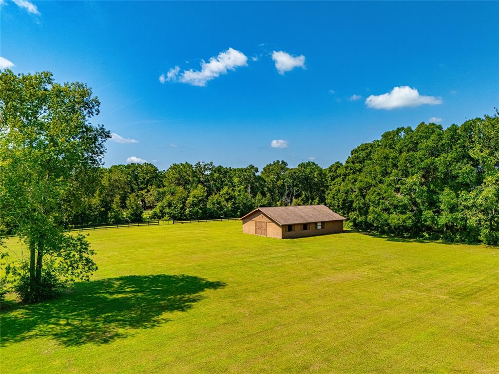 A single-story brown brick building with a garage and a large grassy yard — 9901 SW 67TH TERRACE, OCALA, FL
