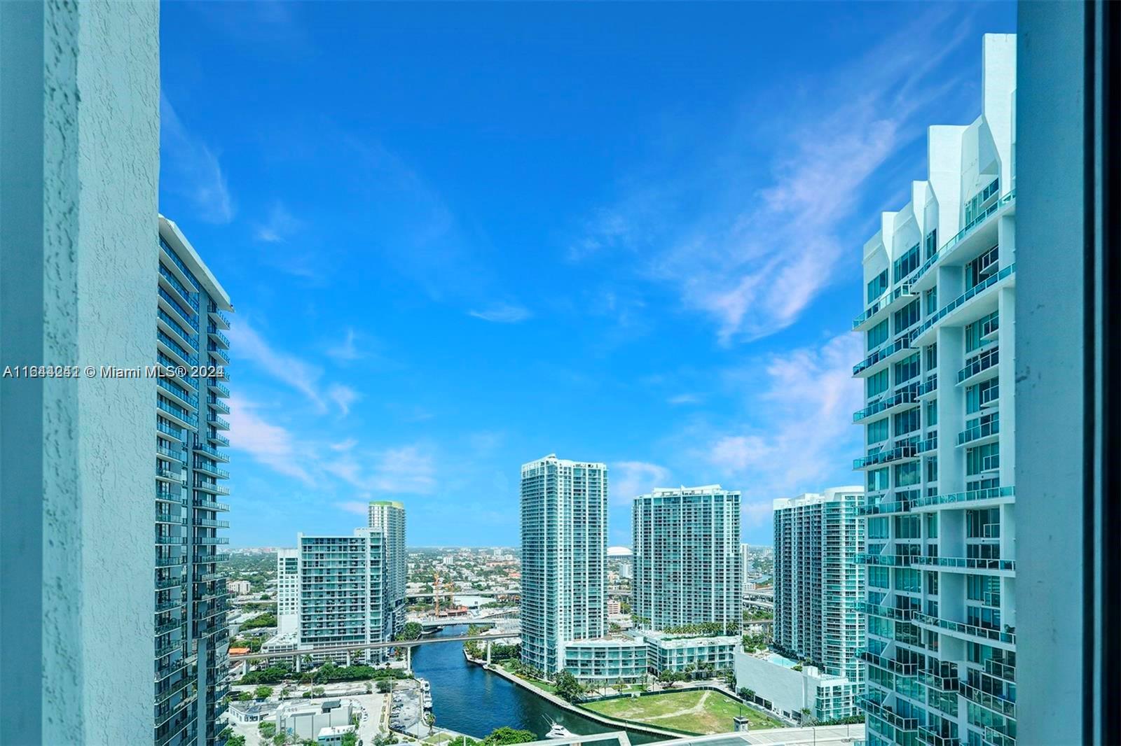 A high-angle view shows a city skyline with modern high-rise buildings and a canal — 55 SE 6th St # 3401, Miami FL 33131, MIAMI, FL