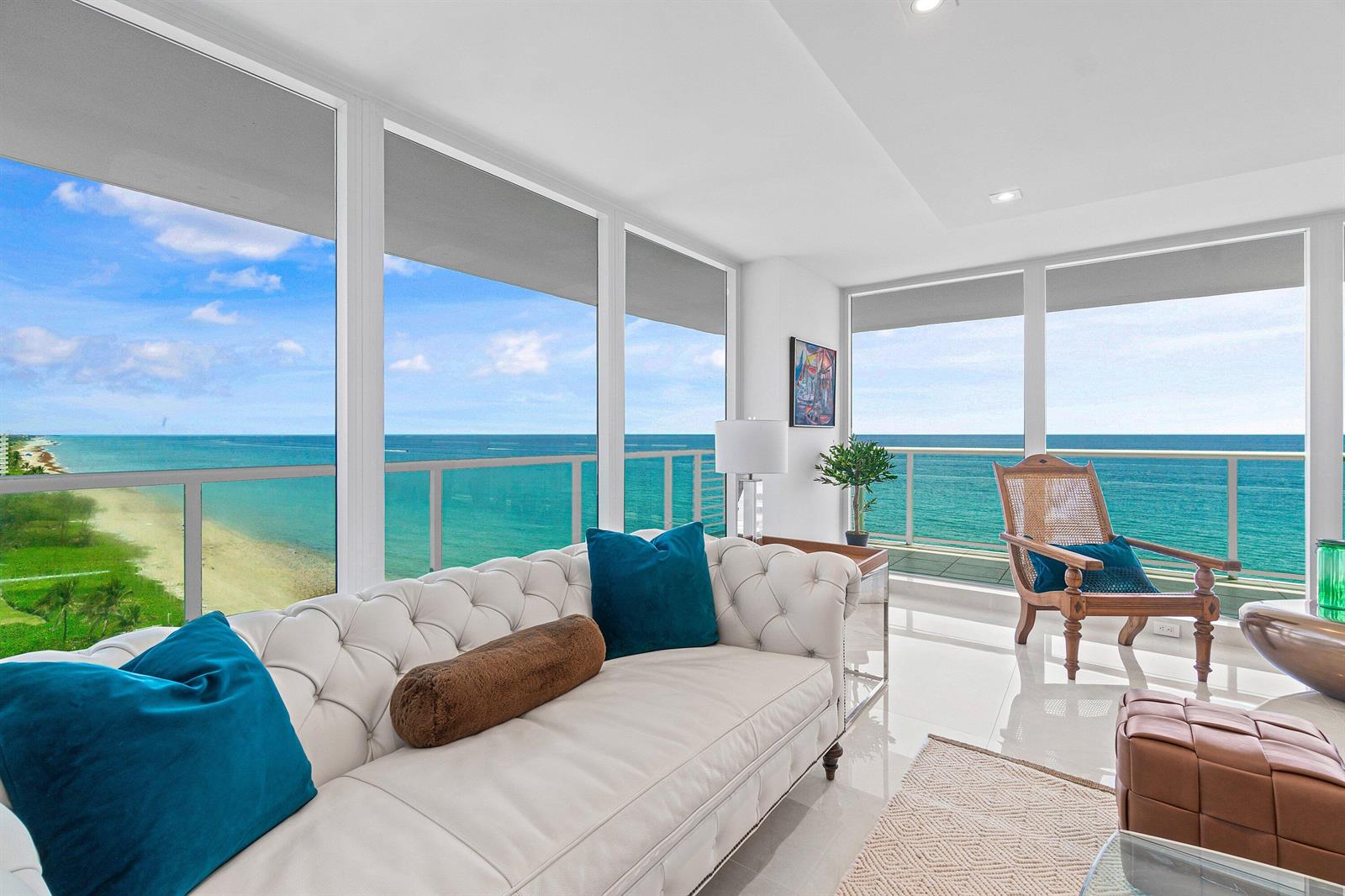 A living room with a tufted white sofa, ocean views, and a balcony — 3505 S Ocean Boulevard # 12n, Highland Beach FL 33487, HIGHLAND BEACH, FL
